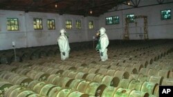 RUSSIA -- Two Russian soldiers make a routine check of metal containers with toxic agents at a chemical weapons storage site in the town of Gorny, May 20, 2000.