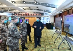 Chinese President Xi Jinping learns about the hospital's operations, treatment of patients, protection for medical workers and scientific research in Wuhan, the epicenter of the novel coronavirus outbreak, Hubei province, March 10, 2020.