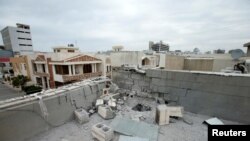 FILE - A damaged roof is seen after a barrage of rockets hit in and near Erbil International Airport in Erbil, Iraq, Feb. 16, 2021.