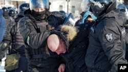 Police detain a man during a protest against the jailing of opposition leader Alexei Navalny in Khabarovsk, 6,100 kilometers (3,800 miles) east of Moscow, Russia, Saturday, Jan. 23, 2021. Authorities in Russia have taken measures to curb protests…