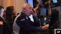 Traders work on the floor of the New York Stock Exchange, March 11, 2025.