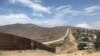 A fence runs along the U.S.-Mexico border.