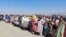 Afghan citizens wait with their belongings to cross into Afghanistan, after Pakistan gives the last warning to undocumented immigrants to leave, at the Friendship Gate of Chaman Border Crossing in Chaman, Pakistan, Oct. 31, 2023. 