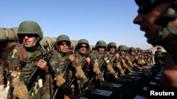 FILE - Afghan soldiers take their oaths before a training exercise at the Kabul Military Training Center, Oct. 22, 2014. 