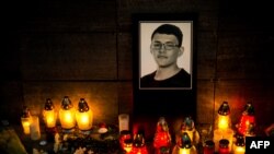 Candles and an image of investigative journalist Jan Kuciak are left outside Aktuality, the Slovakian news outlet where he worked. (Vladimir Simicek | AFP)