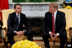 President Donald Trump speaks during a meeting with Brazilian President Jair Bolsonaro in the Oval Office of the White House, March 19, 2019, in Washington.