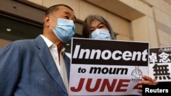 FILE - Media mogul Jimmy Lai, founder of Apple Daily, and activist Leung Kwok-hung arrive at West Kowloon Courts in Hong Kong on Oct. 15, 2020. Lai's trial was adjourned on June 3, 2024, because he felt ill.