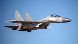 FILE - In this undated photo released by the Taiwan Ministry of Defense, a Chinese PLA J-16 fighter jet flies in an undisclosed location. China flew more than 30 military planes toward Taiwan on Oct. 2, 2021.