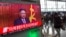 People walk past a television news broadcast at a railway station in Seoul on Jan. 1, 2017, showing North Korean leader Kim Jong-Un's New Year's speech.