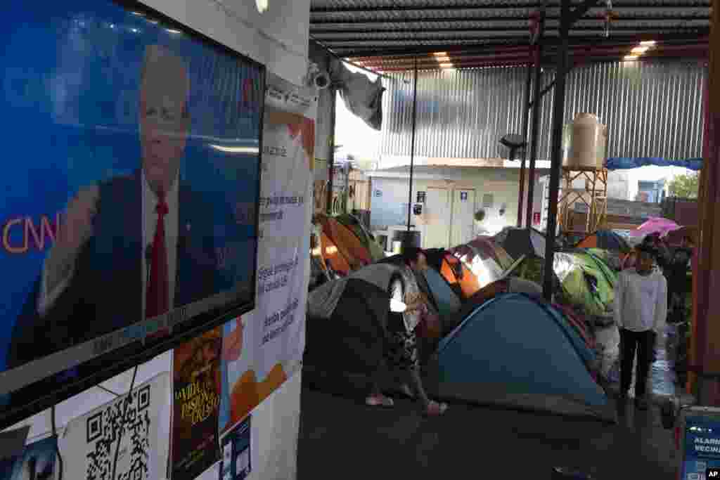 ជនអន្តោប្រវេសន៍​ដែល​រង់ចាំ​សុំសិទ្ធិ​ជ្រកកោន​កំពុង​មើល​ការជជែក​ដេញ​ដោល​ប្រធានាធិបតី​កាលពីថ្ងៃទី​២៧ មិថុនា ឆ្នាំ​២០២៤ ក្នុង​ទីក្រុង Tijuana ប្រទេស​ម៉ិកស៊ិក។(AP Photo/Gregory Bull)