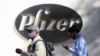 People walk by the Pfizer world headquarters in New York on Nov. 9, 2020.