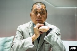 FILE - In this picture taken on June 16, 2020, media tycoon Jimmy Lai poses during an interview with AFP at the Next Digital offices in Hong Kong.