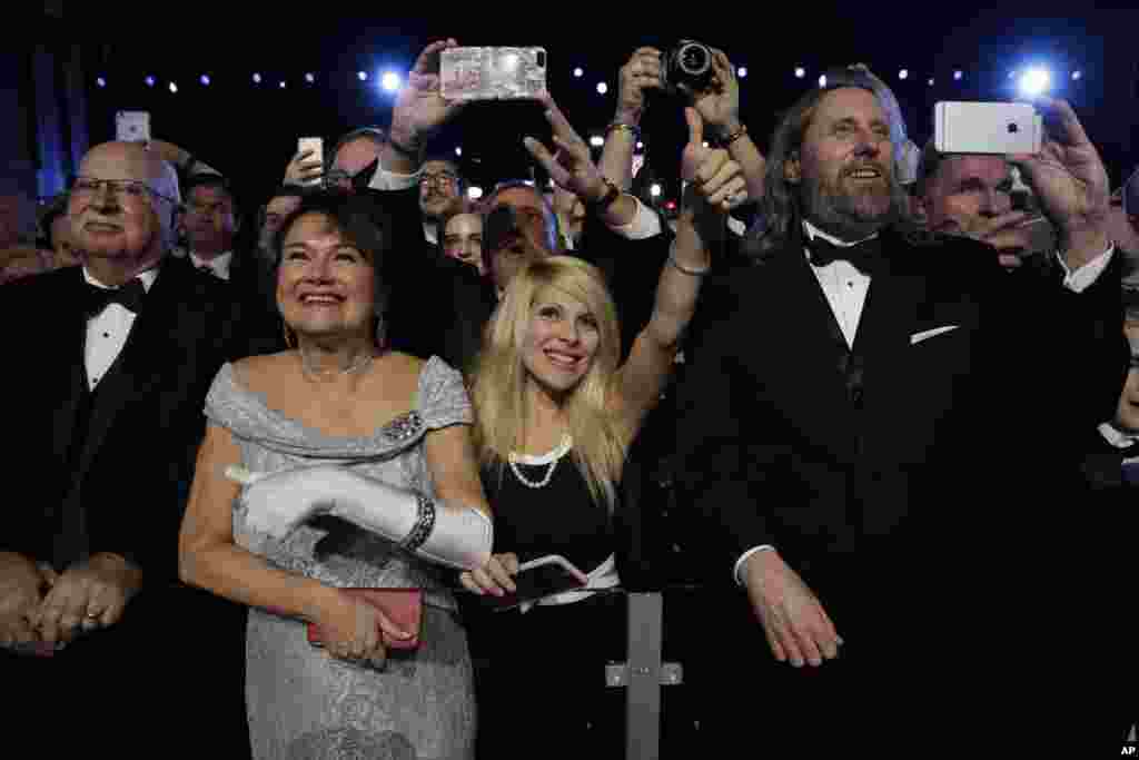 People listen to President Donald Trump at the Freedom Ball, Jan. 20, 2017, in Washington. 
