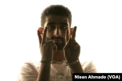 Mohammed-Noor Mattar, 22, a media activist from Raqqa showing a victory sign while handcuffed during a campaign against oppression. After he was kidnapped by the Islamic State in 2013, his family never heard anything of his fate.