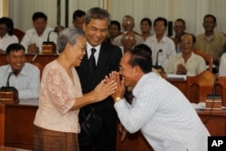 FILE - Youk Chhang, executive director of the Documentation Center of Cambodia (DC-Cam) has spent more than 30 years collecting documents about the Khmer Rouge, and his mother, Keo Nan, met with the villagers from Trapeang Veng village in 2012.