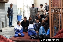 China -- Children join the adults at a mosque for Friday prayers in Urumqi, the capital of farwest China's Muslim Uighur homeland of Xinjiang, May 23, 2014