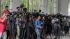 FILE - Reporters cover proceedings outside a court in Dhaka, Bangladesh, May 3, 2016. A Bangladeshi journalists group is expressing outrage over the recent detention and one year sentence given to Bangla Tribune correspondent Ariful Islam. 