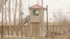 FILE - A security guard watches from a tower at a detention facility in China's Xinjiang Uyghur Autonomous Region on March 21, 2021. An analyst says China's sanctions of members of the European Parliament over the Xinjiang issue is making cooperation with Europe more difficult.