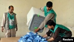 Afghan election workers prepare to start counting ballot papers after voting closed at a polling station in Mazar-I-Shariff, June 14, 2014.