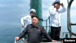 朝鲜官方媒体2014年6月公布的照片显示领导人金正恩视察一艘老旧潜艇。美国研究人员说，卫星图像分析显示，朝鲜可能已获得一艘新潜艇。
