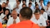 FILE PHOTO- Former Vice President of opposition party Cambodia National Rescue Party Pol Ham, center left, prays together with his former party lawmaker Son Chhay, center right, during a Buddhist ceremony, in Phnom Penh, Cambodia, March 30, 2018. (AP Photo/Heng Sinith)