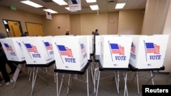FILE - Poll workers with the Hillsborough County Supervisor of Elections Office work to set up early voting equipment at the Seffner-Mango Branch Library in Seffner, Florida, August 2, 2024. 