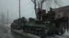 Members of the Ukrainian armed forces ride armored personnel carriers near the government-held industrial town of Avdiivka, Ukraine, Feb. 4, 2017. 