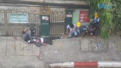 People approach an injured man with a gunshot wound amid protests against the military coup in Yangon, Myanmar, February 28, 2021, in this still image from video obtained via social media. (Credit: Myanmar Now)
