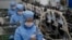 FILE - Workers of the Ryongaksan Soap Factory make disinfectant in Pyongyang, North Korea, March 19, 2020.