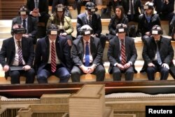White House national security adviser John Bolton (2nd R) wears virtual reality goggles during a visit to the Western Wall tunnel complex in Jerusalem's Old City, Jan. 6, 2019.