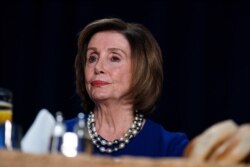 Speaker of the House Nancy Pelosi of Calif., listens as President Donald Trump speaks at the 68th annual National Prayer Breakfast, Feb. 6, 2020, in Washington.