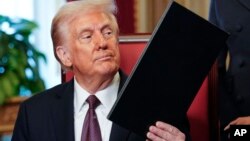 President Donald Trump, center, takes part in a signing ceremony at the U.S. Capitol in Washington, Jan. 20, 2025.