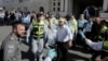 Israeli emergency personnel carry a covered body from the scene of an attack at a Jerusalem synagogue, Nov. 18, 2014. 