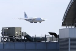 FILE - A Russian military transport plane carrying medical equipment, masks and supplies lands at JFK International Airport during the outbreak of the coronavirus disease (COVID-19) in New York City, New York, April 1, 2020.