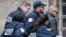 Former Kosovo prime minister Ramush Haradinaj, right, is rushed by police officers inside the Colmar courthouse in France, Jan.5, 2017. Haradinaj is facing possible extradition to Serbia to face war crimes charges after being arrested at a French airport.