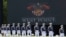 FILE - United States Military Academy graduating cadets, wearing face masks, march to their socially-distanced seats during commencement ceremonies in West Point, New York, June 13, 2020.
