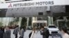 Les gens passent devant le siège de Mitsubishi Motors Corp, qui est allié à Renault-Nissan, le lundi 26 novembre 2018 à Tokyo. (Photo AP / Koji Sasahara)