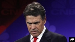 美国共和党总统参选人佩里11月9日晚在密西根州的辩论会上查看自己的笔记