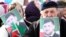 FILE - People hold portraits of Chechen leader Ramzan Kadyrov as they take part in a rally marking the 13th anniversary of the adoption of the Constitution of Russian region of Chechnya, in the regional capital of Grozny, March 23, 2016.