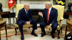 FILE - White House Chief of Staff John Kelly talks with President Donald Trump in the Oval Office of the White House, in Washington, July 31, 2017. 