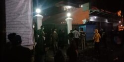 Petugas memasang baligo berisi Pergub Jabar tentang Ahmadiyah di masjid Al Aqsa, Singaparna, Kabupaten Tasikmalaya, Kamis malam, 9 April 2020. (Courtesy: Ahmad Rizal)
