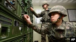South Korean army soldiers adjust equipment used for propaganda broadcasts near the border area between South Korea and North Korea in Yeoncheon, South Korea, Friday, Jan. 8, 2016.