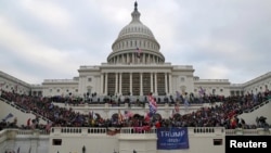 FILE - The U.S. Capitol Building is stormed by a pro-Trump mob on Jan. 6, 2021.