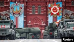 Russian military vehicles including Yars intercontinental ballistic missile systems drive along Red Square during a parade on Victory Day, which marks the 76th anniversary of the victory over Nazi Germany in World War II, in Moscow, May 9, 2021.