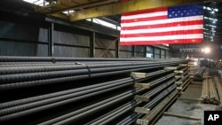 FILE - Steel rods produced at the Gerdau Ameristeel mill await shipment in St. Paul, Minn., May 9, 2019. Presidential candidate Donald Trump promises new tariffs if elected, saying the U.S. is being taken advantage of by other countries due to its trade policy. 