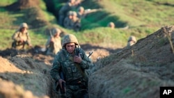 Armenian soldiers take their position on the front line in Tavush region, Armenia, July 14, 2020. Skirmishes on the volatile Armenia-Azerbaijan border escalated Tuesday, marking the most serious outbreak of hostilities between the neighbors since 2016. 