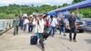 A group of Myanmar migrant workers cross the border between Thailand and Myanmar near the Thai port city of Ranong, July 3, 2017.