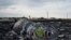 Flowers are placed on a plane engine at the crash site of a Malaysia Airlines jet near the village of Hrabove, eastern Ukraine, July 19, 2014.