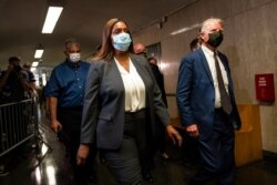 Letitia James, attorney general of New York, and Cyrus Vance Jr., New York County district attorney, leave Manhattan criminal court, July 1, 2021, in New York.
