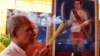 Cambodian man holds the burned incense sticks in front of a painted photo of a Kampuchea Krom Hero, Son Kuy, right, at a ceremony in Phnom, file photo. 